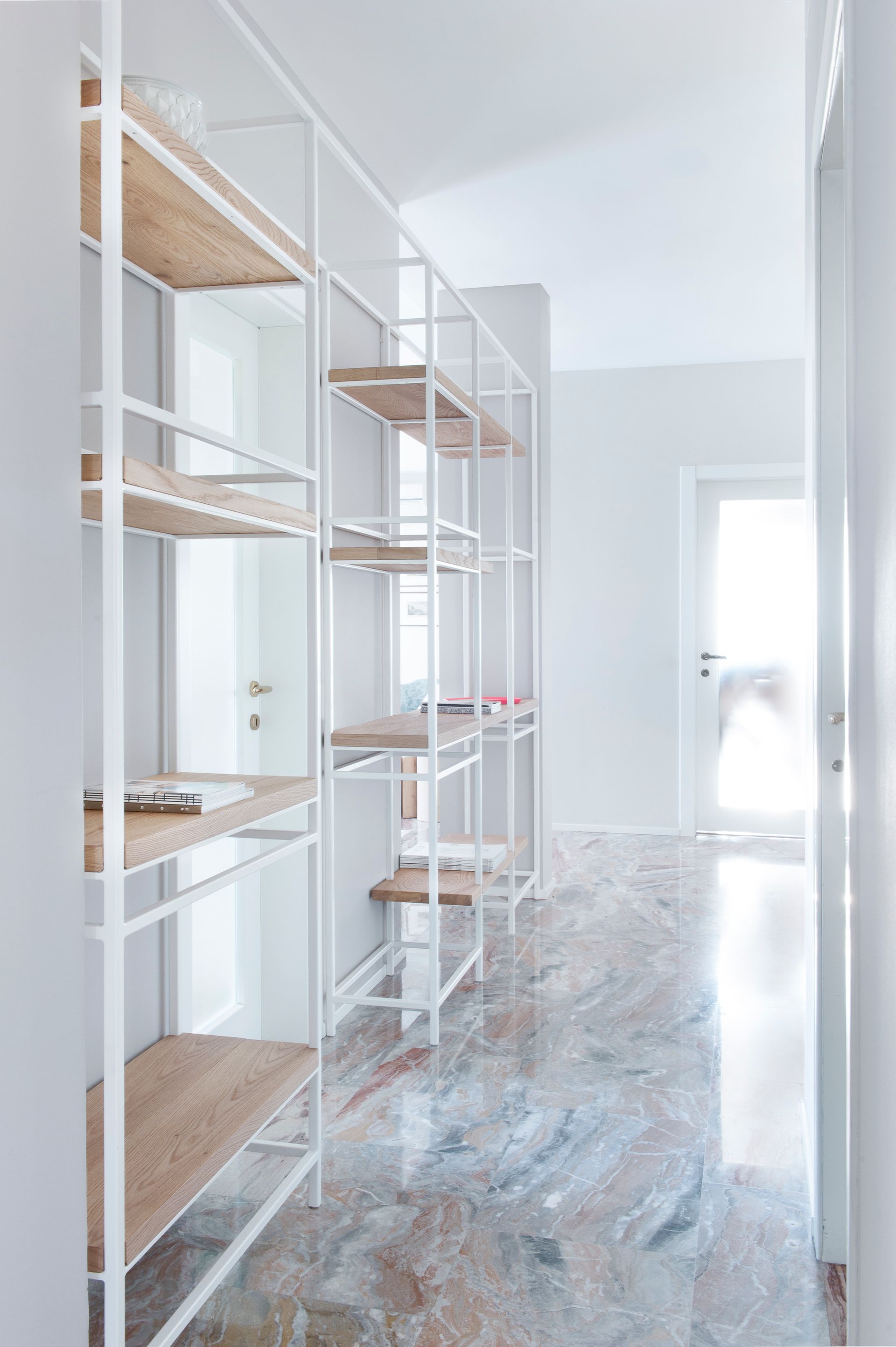 interior design project, luxury apartment renovation in the center of Bergamo, arabescato orobico marble, custom made bookcase, pieces of design - bookcase
